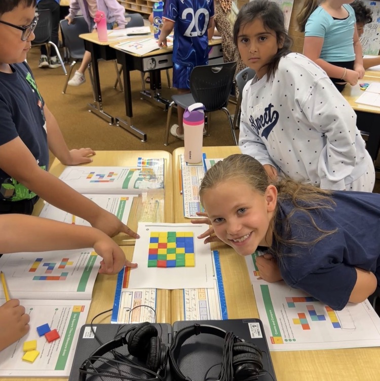 3rd graders working to learn about area using square tiles in math