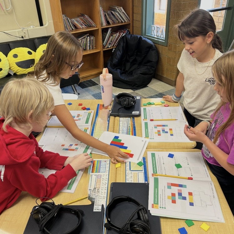 3rd graders working to learn about area using square tiles in math