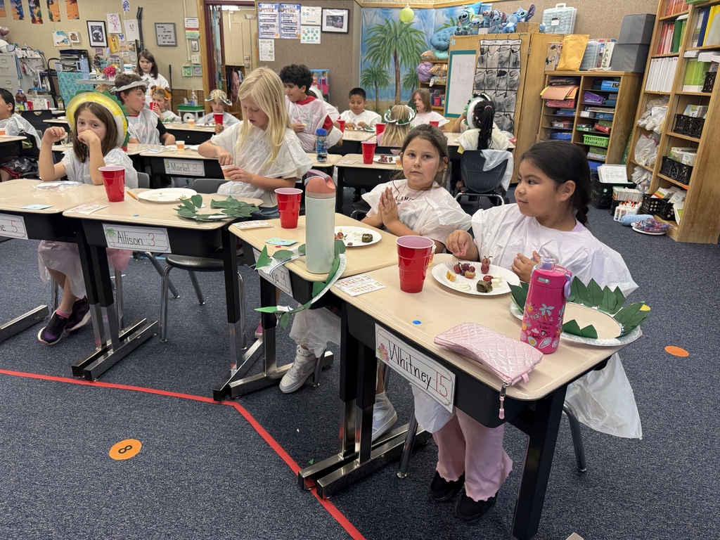 Students enjoy a celebration of learning about Ancient Greece by making “laurel” crowns and trashbag togas, eating dolmades (stuffed grape leaves), tzatziki, olives, cow and sheep feta cheese, bread with olive oil, grapes, and drinking grape juice.