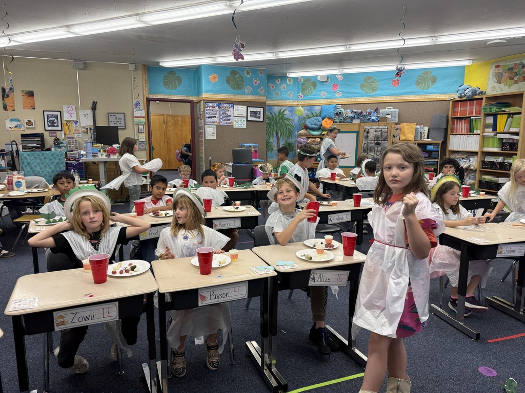 Students enjoy a celebration of learning about Ancient Greece by making “laurel” crowns and trashbag togas, eating dolmades (stuffed grape leaves), tzatziki, olives, cow and sheep feta cheese, bread with olive oil, grapes, and drinking grape juice.