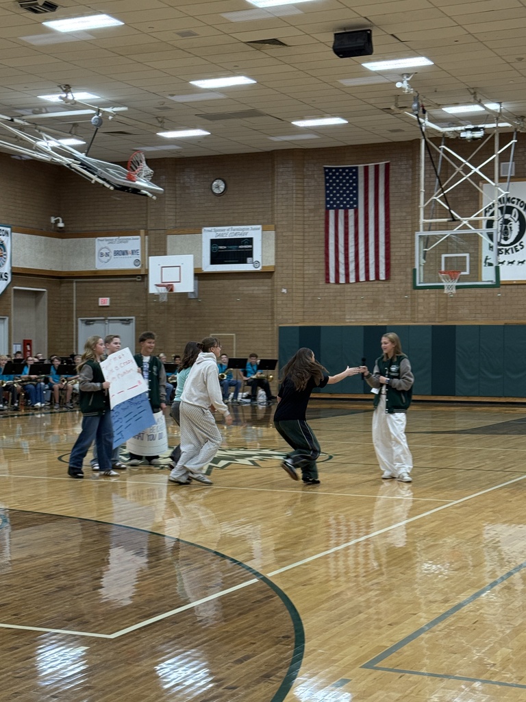 Students playing a game where they have to finish the rest of the lyrics to a song first during the assembly. 