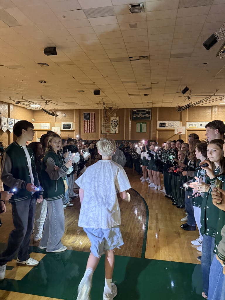 Introducing the new basketball team to the school during the assembly. 
