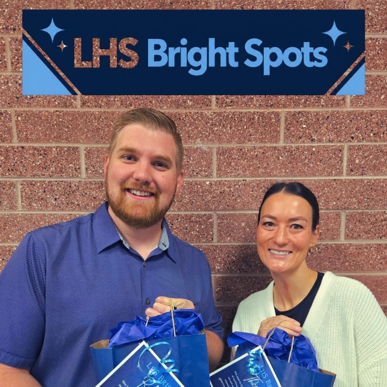 Mr. Davis and Mrs. Holland holding their bright spot awards