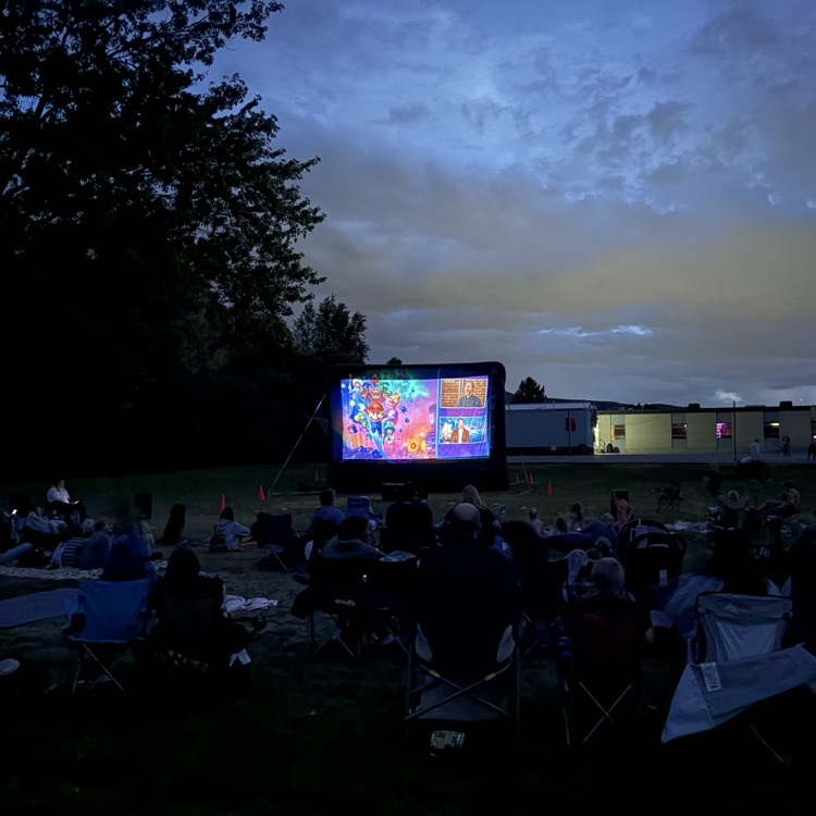 People sitting outside watching a movie