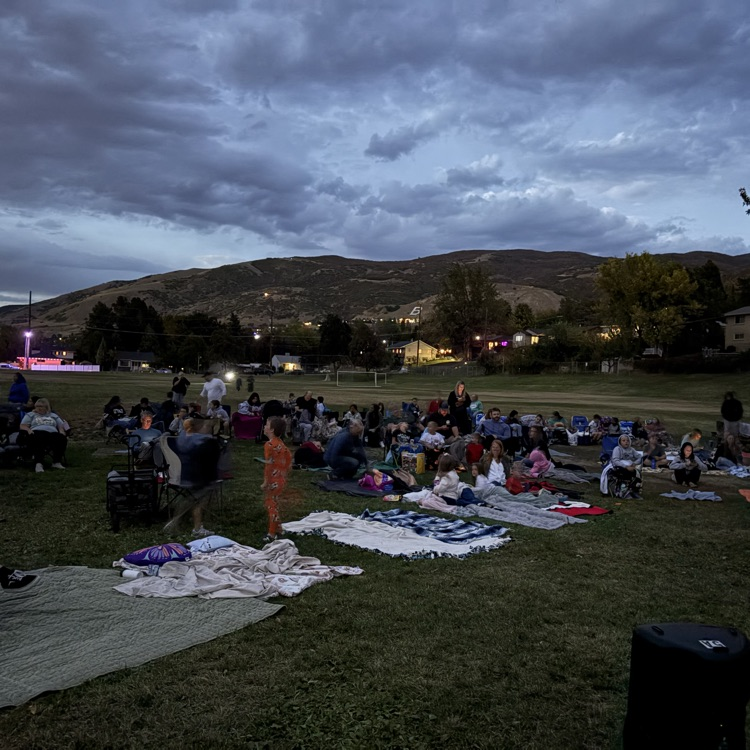 People sitting outside watching a movie