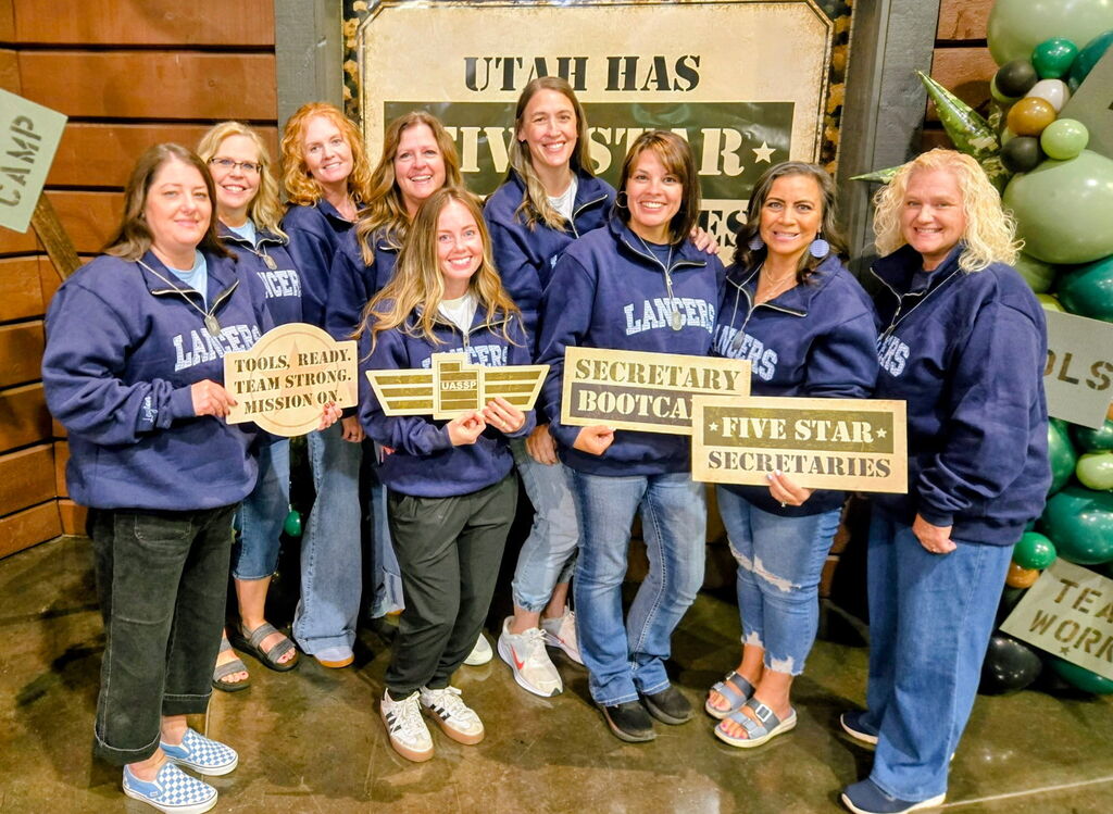 nine layton high secretaries posing for a picture at the UASSP conference
