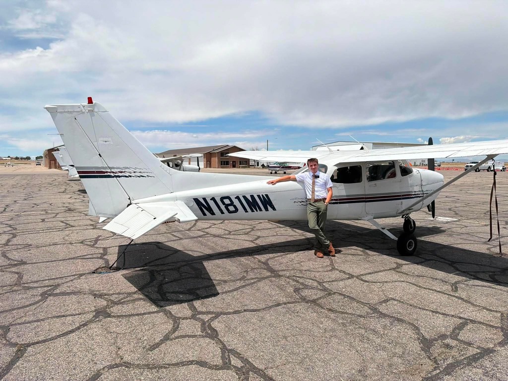 Matthias standing by a Cessna 172 as a missionary