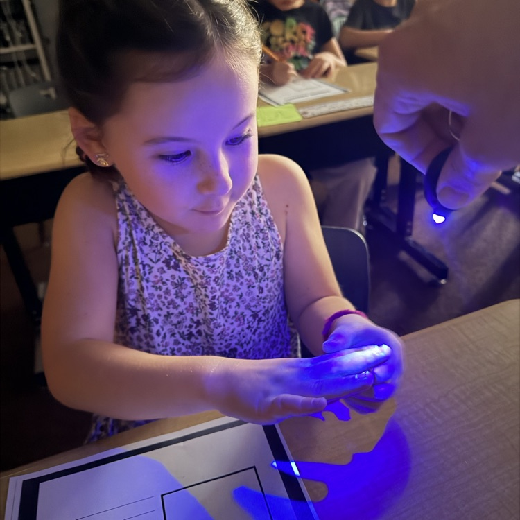 1st graders experimenting with germs, they got to use a blacklight to see their practice of spreading germs to learn the importance of hand washing
