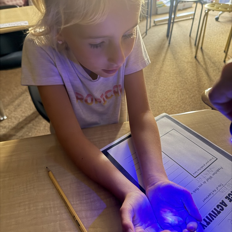 1st graders experimenting with germs, they got to use a blacklight to see their practice of spreading germs to learn the importance of hand washing