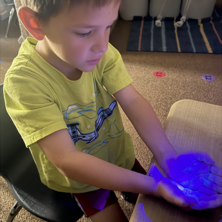 1st graders experimenting with germs, they got to use a blacklight to see their practice of spreading germs to learn the importance of hand washing