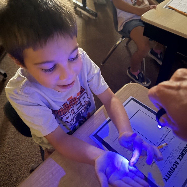 1st graders experimenting with germs, they got to use a blacklight to see their practice of spreading germs to learn the importance of hand washing