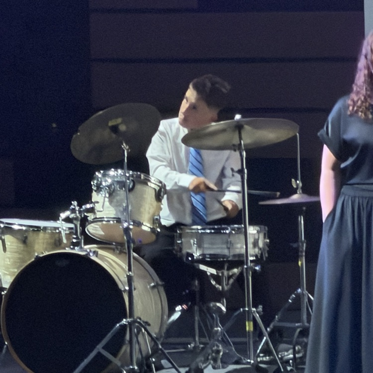 one male student plays the drums