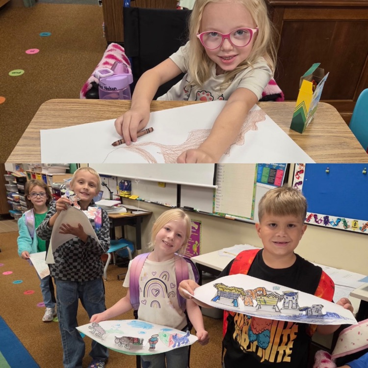 1st graders showing the project they created after their fairy tales unit 