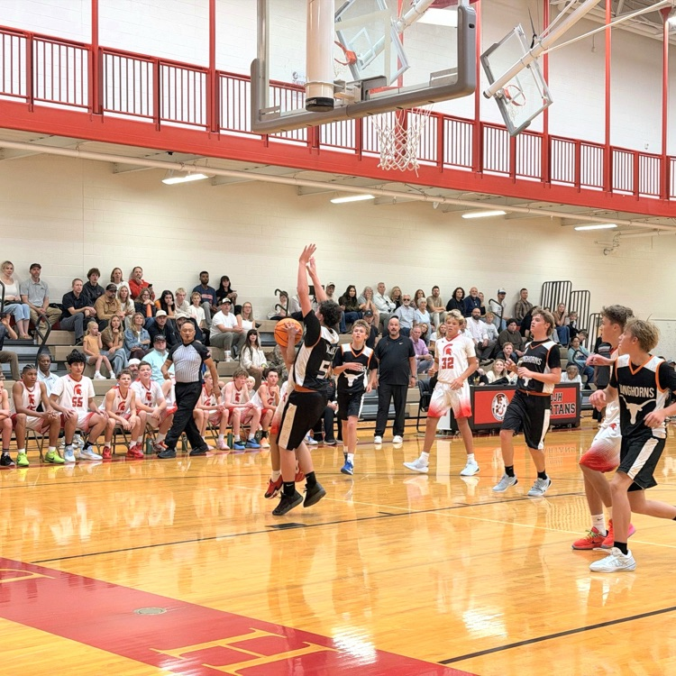 Boys basketball players compete beneath the hoop at South Davis Junior High.