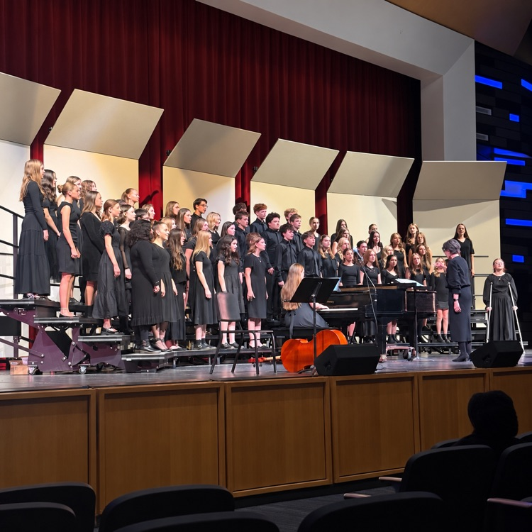 South Davis choir performs in black concert attire with a pianist and conductor.