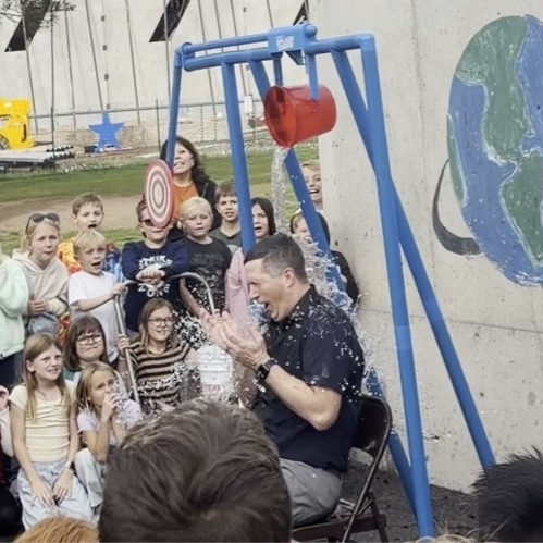 The principal getting water dumped on him  