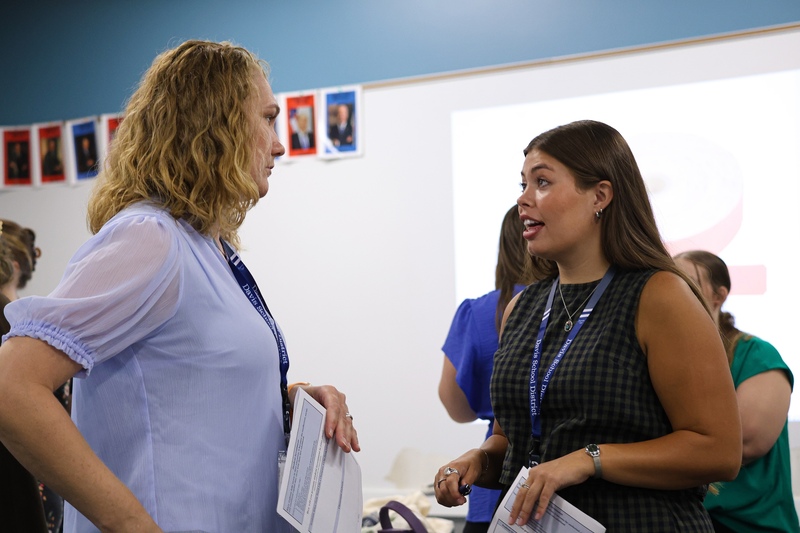 Two teachers talking in class.