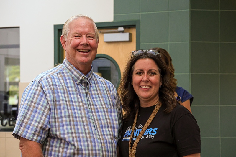 Two people smiling at the camera