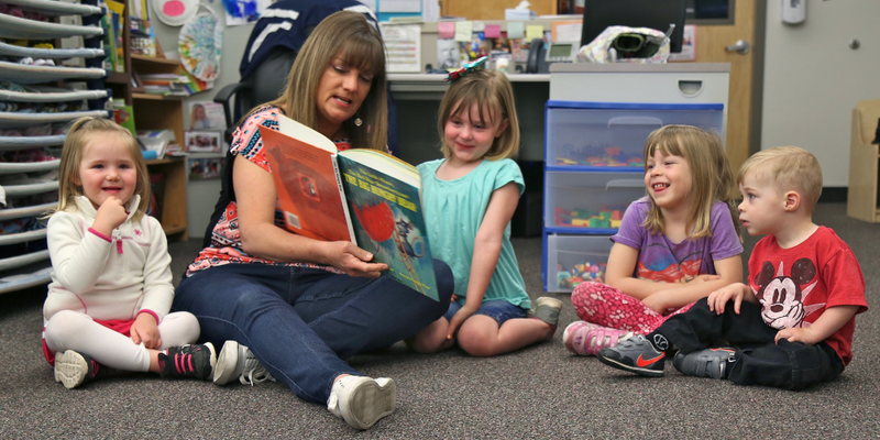Kids reading with a parent.