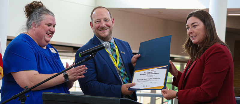 The Utah PTA President and Bountiful City Mayor presenting Millcreek Junior High with an award.