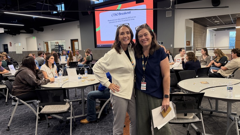 Two CTE coordinators, Natalie Stromberg and Lindsay Porter, pose for a picture at the conference.