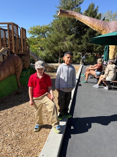 Two students pose on the playground.