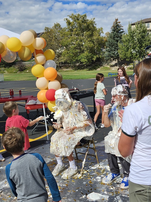 Principal, Vice Principal and PE coach getting pied in on the playground watched by students