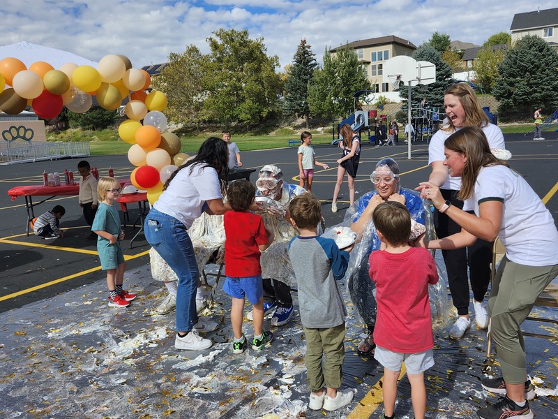 Principal, Vice Principal and PE coach getting pied in on the playground watched by students