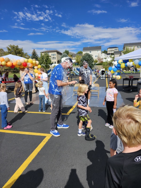 Principal, Vice Principal and PE coach getting pied in on the playground watched by students