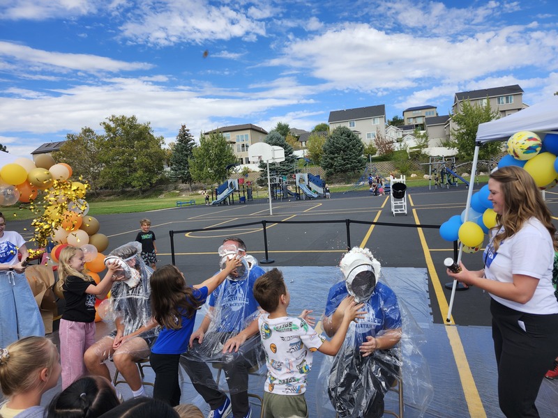 Principal, Vice Principal and PE coach getting pied in on the playground watched by students