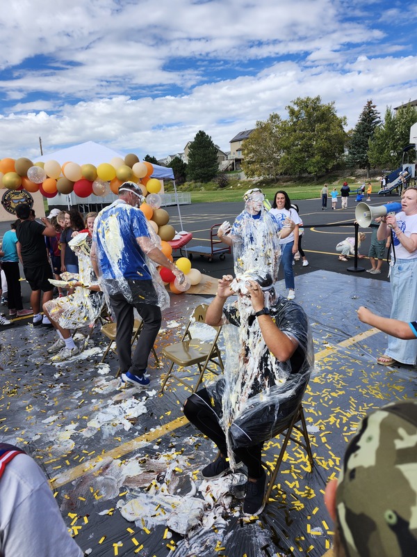 Principal, Vice Principal and PE coach getting pied in on the playground watched by students