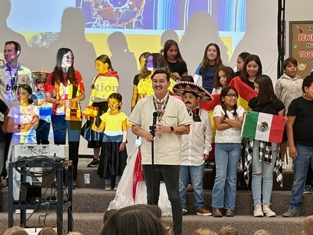 Mr. Tomsik starting the Assembly with students and teachers behind him.