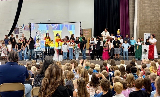 Hispanic students and teachers on the stage after the parade.
