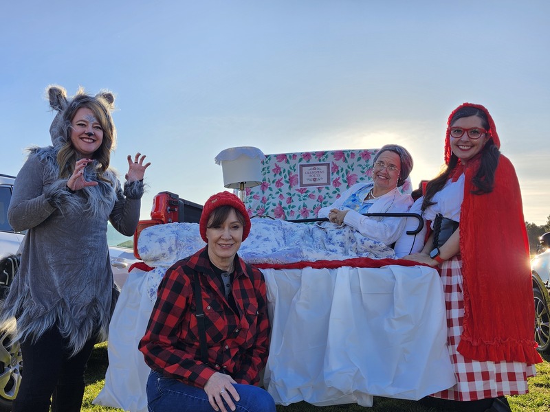 1st grade teachers dressed up as Little Red Riding Hood characters in decorated trunk