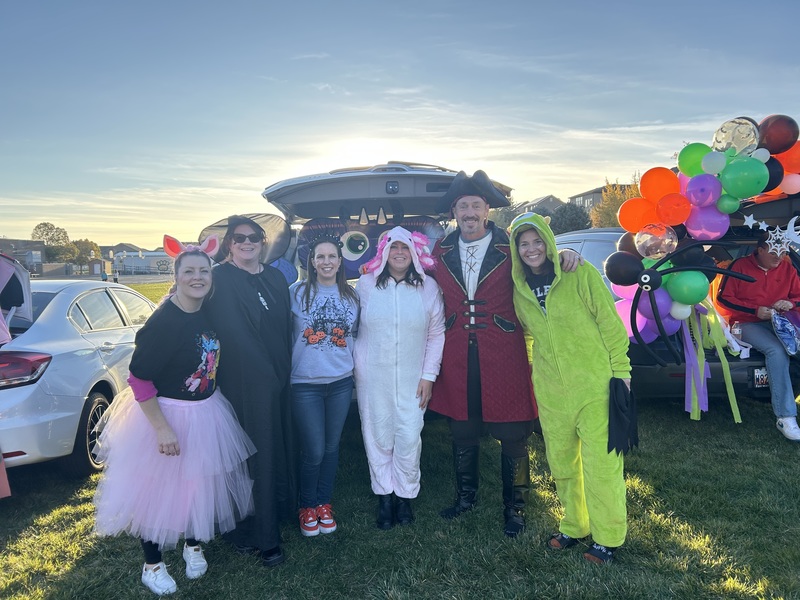 Office staff in front of decorated trunk