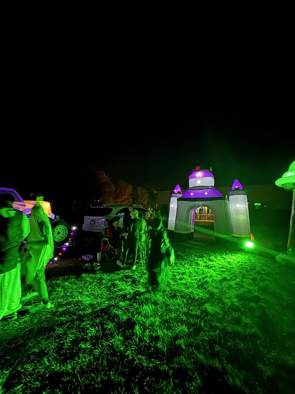 Spooky green light on castle blowup during trunk or treat