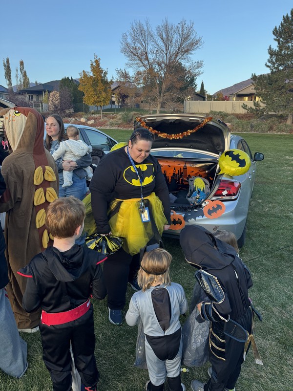 Teacher passing out candy in batman costume