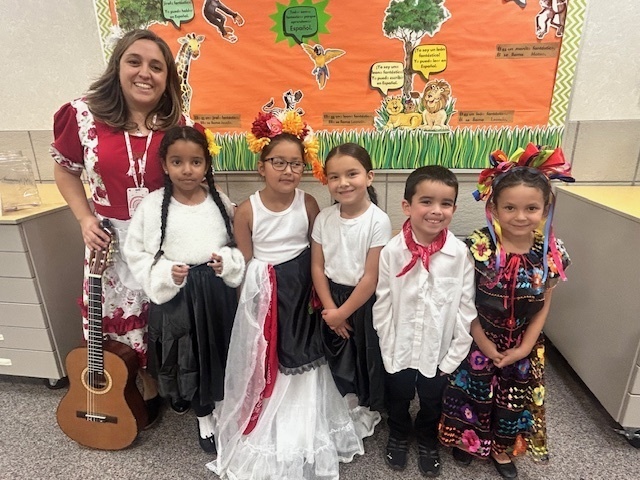 Mrs. Hernandez and 1st grade students in Hispanic Heritage clothing