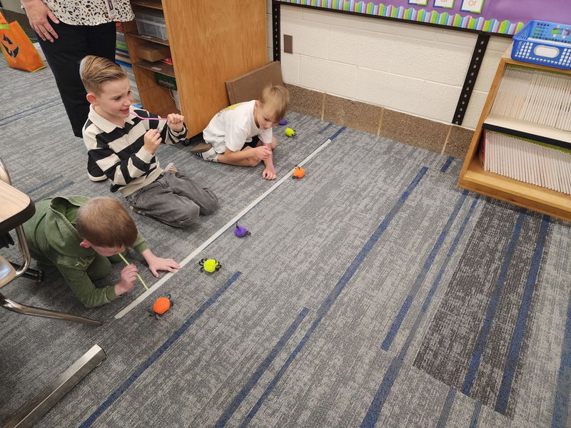 2nd grade students playing a game on Halloween in their classroom.