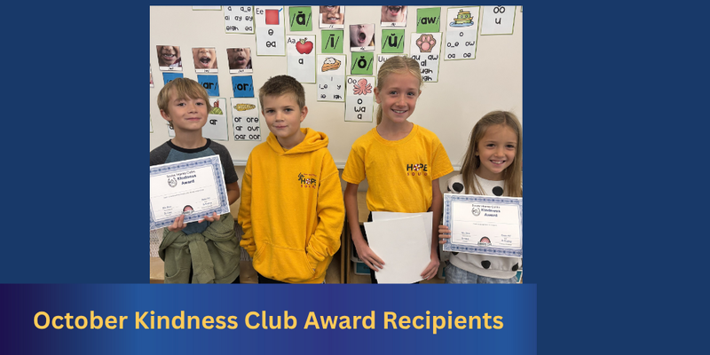 Four students in front of a whiteboard