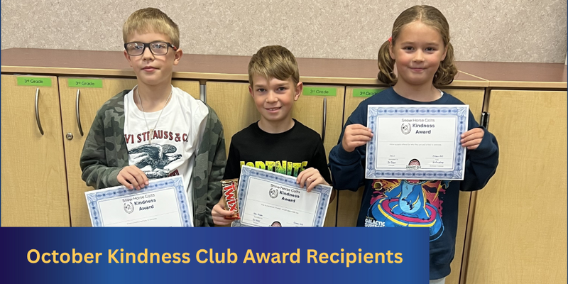 Three students holding certificates