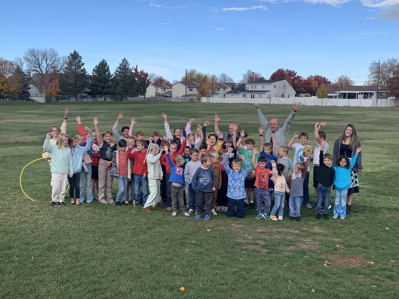 Photo of students outside for recess with school admin