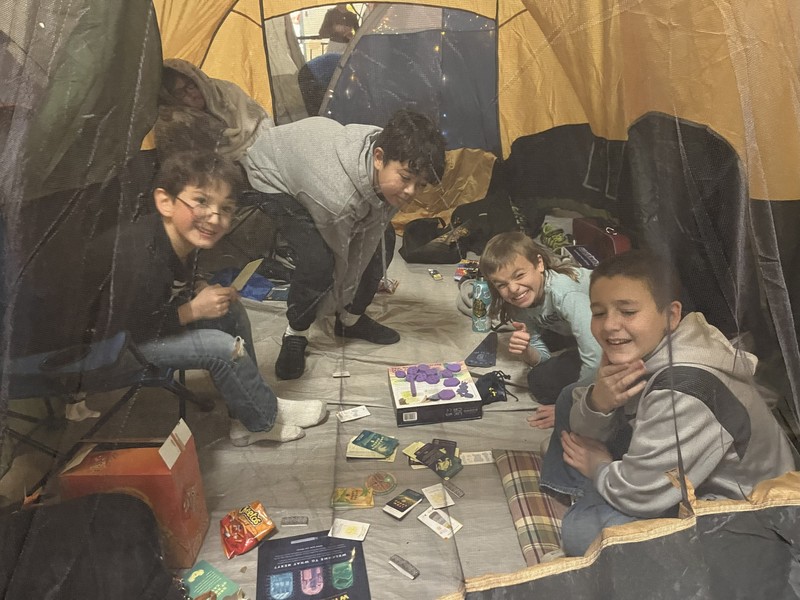 6th graders playing games in a tent