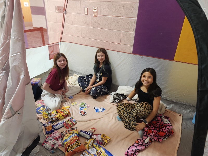 6th graders playing games in a tent
