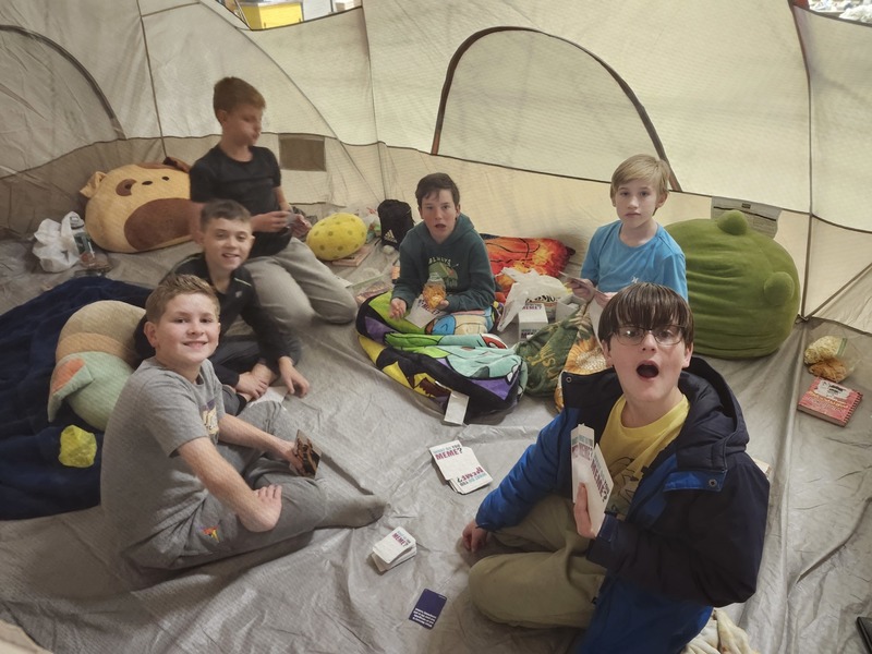 6th graders playing games in a tent