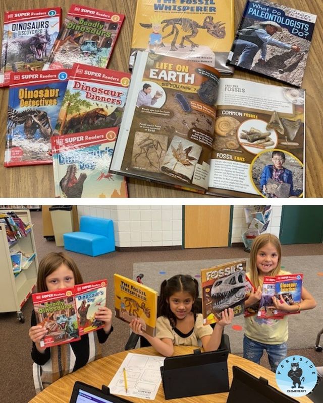 Students holding dinosaur books in their hands