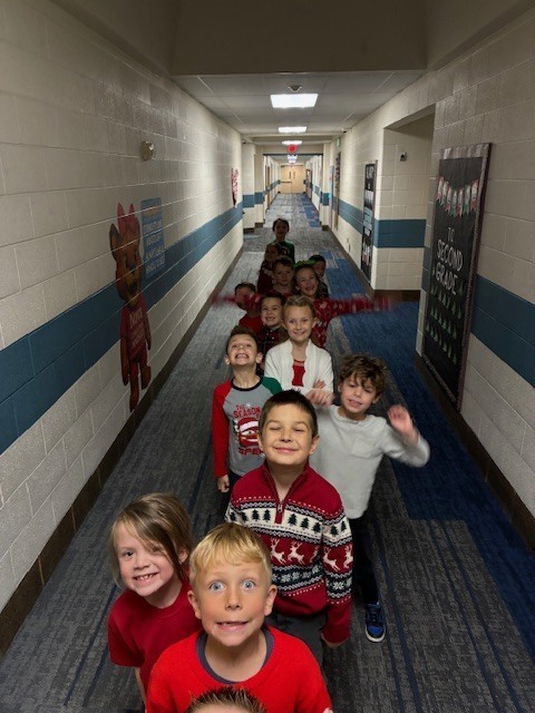 Students dressed up for the play, lined up in the hallway.