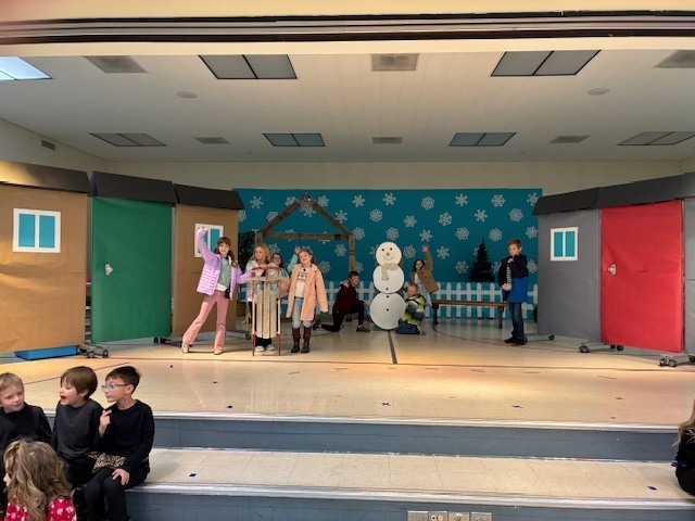 Students performing on the stage.