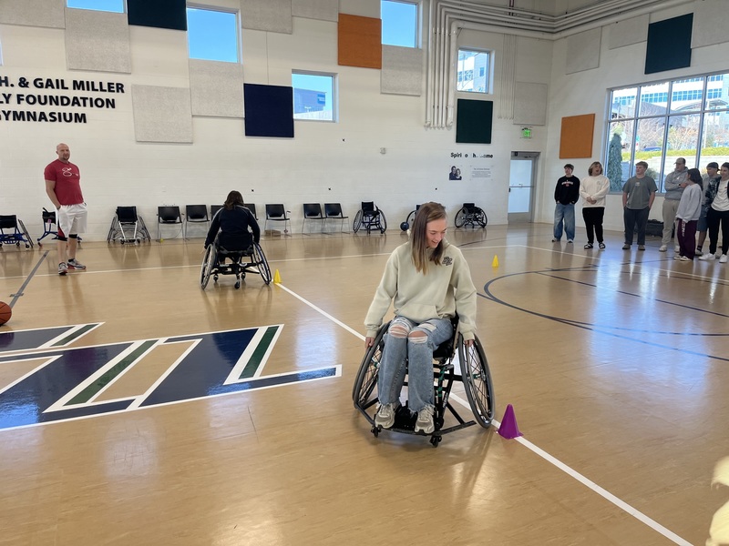Students navigating obstacle course in wheelchairs.