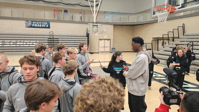 AJ talking with the basketball team